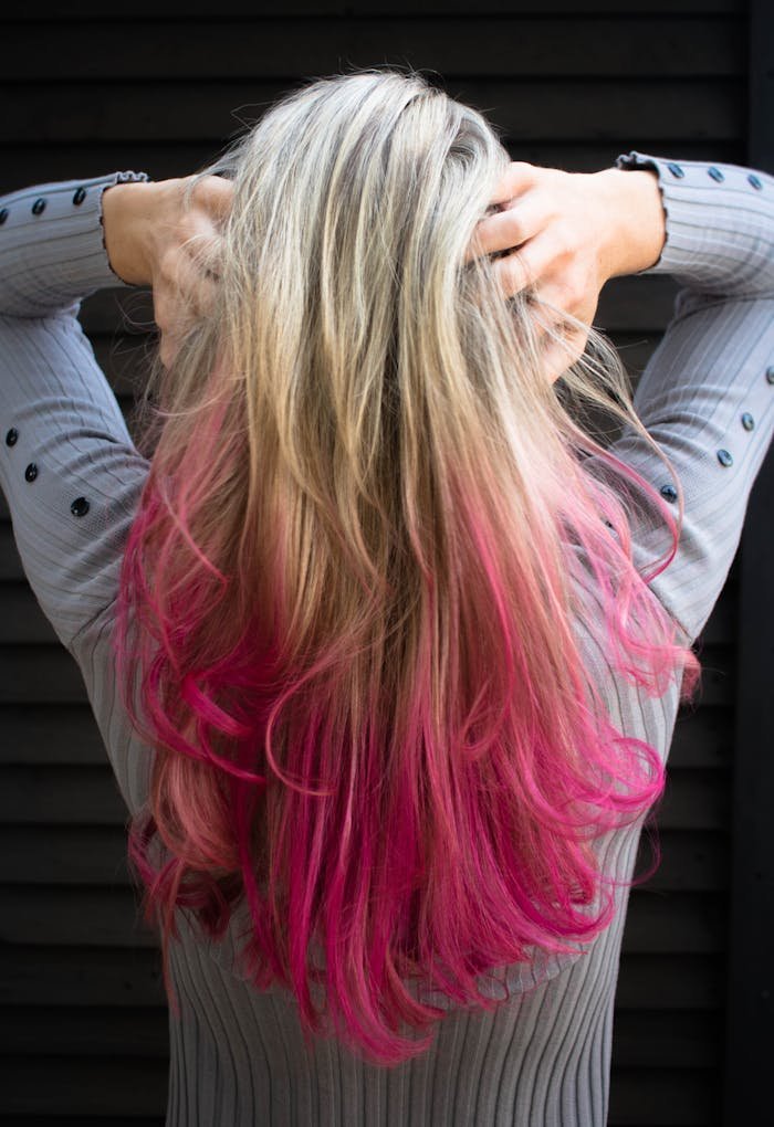 hero-gallery-01 Close-up of a woman with blonde and pink ombre hair in a stylish pose.